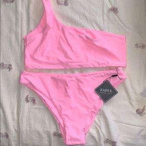 Two piece bright pink bathing suit.